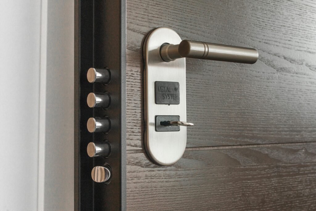 pexels-photo-279810-279810 Metal door handle and lock system with key inserted, showcasing security features.