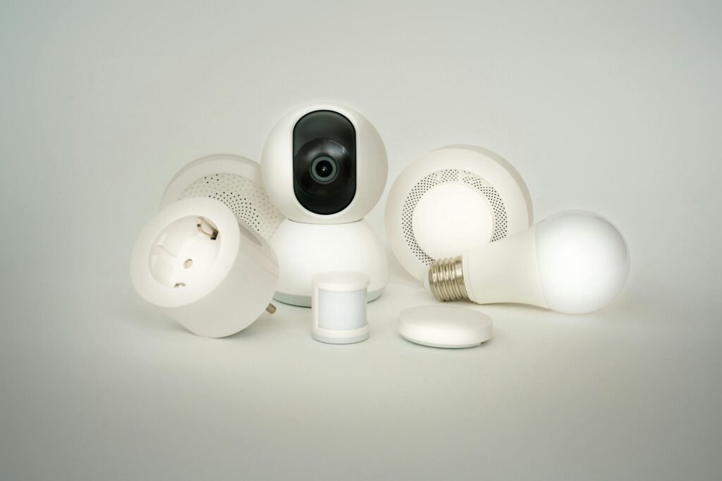 pexels-photo-29091470-29091470 A collection of smart home devices including bulbs, sockets, and cameras on a white backdrop.